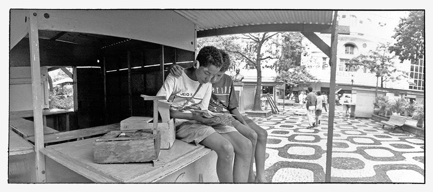 Rio de Janeiro - Street kids taking a break reading comics