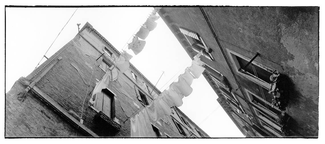 Washed clothes hanging from one building to the other