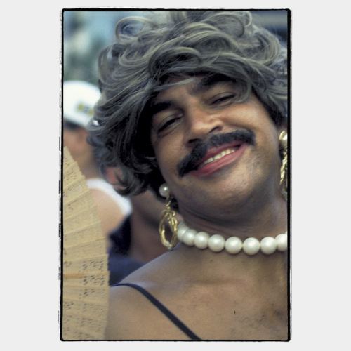 Rio Carnival: happy expression on face of man with woman make up and big moustache