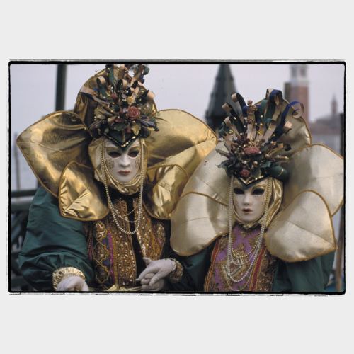 Elegant gold masked couple in Venice