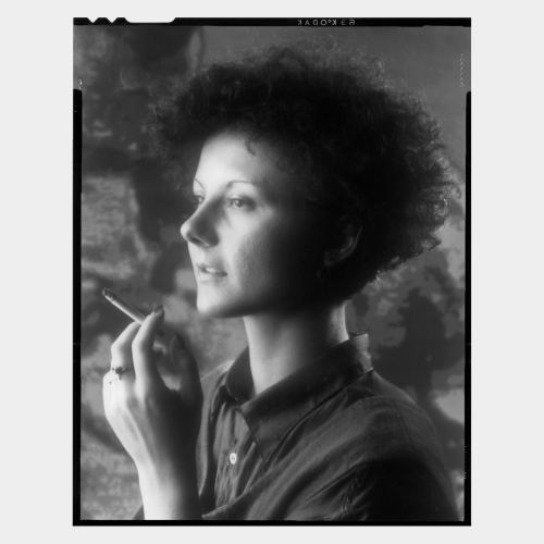 Young woman with curly hair and cigarette