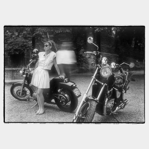Young woman with two heavy nice motorbykes